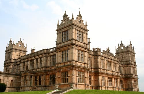 A big stone mansion with grey sky.